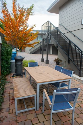 A table and chairs set up on a patio.
